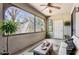 Enclosed patio with large window offers an indoor-outdoor space for relaxation, ceiling fan, and comfortable seating at 15252 N 100Th St # 1147, Scottsdale, AZ 85260