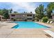 Community pool surrounded by lounge chairs and manicured landscaping at 15252 N 100Th St # 1147, Scottsdale, AZ 85260