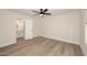 Bright bedroom features light wood floors and a modern ceiling fan with an ensuite bathroom at 15801 N 29Th N St # 20, Phoenix, AZ 85032