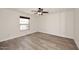 Bright bedroom featuring light wood floors, a window, and a ceiling fan with a light at 15801 N 29Th N St # 20, Phoenix, AZ 85032