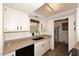 Well-lit kitchen features white cabinets, laminate countertops, and stainless steel sink at 15801 N 29Th N St # 20, Phoenix, AZ 85032