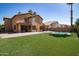 Large backyard with artificial grass, desert landscaping and a fence to the pool at 16071 W Sherman St, Goodyear, AZ 85338