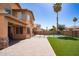 A beautiful backyard with turf, pool, and a covered patio at 16071 W Sherman St, Goodyear, AZ 85338