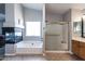 Main bathroom with jacuzzi tub, shower and separate vanity at 16071 W Sherman St, Goodyear, AZ 85338