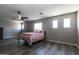 Spacious bedroom featuring a ceiling fan, several windows and wood-look flooring at 16071 W Sherman St, Goodyear, AZ 85338
