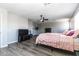 Large bedroom with wood-look flooring, ceiling fan, big window and spacious design at 16071 W Sherman St, Goodyear, AZ 85338