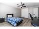 This bedroom features a ceiling fan, wood floors, closet, and modern gray paint at 16071 W Sherman St, Goodyear, AZ 85338