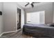 This bedroom features wood floors, blinds, and a closet at 16071 W Sherman St, Goodyear, AZ 85338