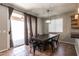 Dining room featuring a rustic wooden table, iron chairs and sliding glass door at 16071 W Sherman St, Goodyear, AZ 85338