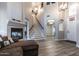 Elegant foyer with hardwood floors, a fireplace, stairs, and high ceilings creating a grand entrance at 16071 W Sherman St, Goodyear, AZ 85338