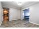Clean and open hallway with hardwood floors, neutral walls and natural light at 16071 W Sherman St, Goodyear, AZ 85338