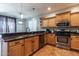 Open kitchen area with a stainless steel sink and appliances, plus granite countertops at 16071 W Sherman St, Goodyear, AZ 85338