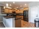 Open kitchen with granite countertops, light wood cabinets, and stainless steel appliances at 16071 W Sherman St, Goodyear, AZ 85338