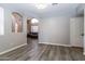Open living room with hardwood flooring, neutral paint, archways and natural light at 16071 W Sherman St, Goodyear, AZ 85338