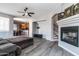 Cozy living room with hardwood floors, a fireplace and an open floor plan to the kitchen at 16071 W Sherman St, Goodyear, AZ 85338