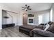 Bright living room area with a fireplace, entertainment center, and comfortable seating at 16071 W Sherman St, Goodyear, AZ 85338