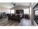 Spacious main bedroom with a dark wood bed set, ceiling fan and natural light at 16071 W Sherman St, Goodyear, AZ 85338