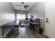 Bright office space featuring a fan, a window with blinds and hardwood floors at 16071 W Sherman St, Goodyear, AZ 85338