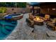 Entertaining backyard area with a heated fire pit, spa, outdoor seating, and a sparkling pool at 16141 N 183Rd Dr, Surprise, AZ 85388