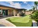 Backyard with a putting green and outdoor kitchen, great for entertaining at 16141 N 183Rd Dr, Surprise, AZ 85388