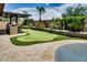 Beautiful backyard with putting green and well manicured landscaping at 16141 N 183Rd Dr, Surprise, AZ 85388