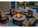 Cozy outdoor seating area featuring a warm fire pit, comfortable chairs, and a lush green lawn in the background at 16141 N 183Rd Dr, Surprise, AZ 85388