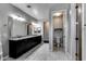 Bathroom featuring dual sinks with granite counters and a separate toilet room at 16141 N 183Rd Dr, Surprise, AZ 85388