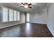 Spacious room with modern finishes, features wood-look floors, a ceiling fan and a bright window at 16141 N 183Rd Dr, Surprise, AZ 85388