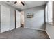 Bedroom with a ceiling fan, neutral walls, and a mounted television at 16141 N 183Rd Dr, Surprise, AZ 85388