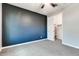 Bedroom featuring dark accent wall and entry to a closet at 16141 N 183Rd Dr, Surprise, AZ 85388