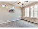 Bedroom with neutral color scheme, shutters and mounted television at 16141 N 183Rd Dr, Surprise, AZ 85388