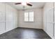 Bedroom featuring wood-look floors, white wainscoting walls, a ceiling fan and a bright window at 16141 N 183Rd Dr, Surprise, AZ 85388