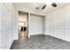 Stylish room features gray walls with white trim, wood-look floors, and adjoins kitchen at 16141 N 183Rd Dr, Surprise, AZ 85388