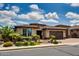 Charming single-story home featuring manicured landscaping, desert plants and a brick driveway at 16141 N 183Rd Dr, Surprise, AZ 85388