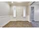 The foyer features wood-style tile flooring, paneled walls and a view into other parts of the home at 16141 N 183Rd Dr, Surprise, AZ 85388