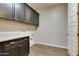 Well-lit laundry room with modern cabinets and granite countertops at 16141 N 183Rd Dr, Surprise, AZ 85388