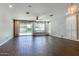 Spacious living room with dark wood tile flooring, ceiling fan, large window and backyard views at 16141 N 183Rd Dr, Surprise, AZ 85388