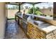 Beautiful outdoor kitchen with stone accents and built in appliances at 16141 N 183Rd Dr, Surprise, AZ 85388