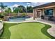 Beautiful backyard with pool, putting green and covered patio seating at 16141 N 183Rd Dr, Surprise, AZ 85388