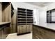 Spacious walk-in closet with custom shelving, drawers, and ample storage; features modern, neutral-toned finishes at 16141 N 183Rd Dr, Surprise, AZ 85388