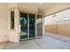 This covered patio features an open sliding door to view the low maintenance backyard with rock landscaping beyond at 16158 W Coronado Rd, Goodyear, AZ 85395
