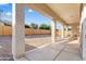 This covered patio features supporting beams and an open view to the large, low maintenance rock landscaping beyond at 16158 W Coronado Rd, Goodyear, AZ 85395