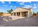 The home's backyard features low maintenance landscaping, a covered patio, and a tall fence for privacy and security at 16158 W Coronado Rd, Goodyear, AZ 85395