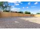 The home features low maintenance landscaping and a tall fence to provide privacy and security to the occupants at 16158 W Coronado Rd, Goodyear, AZ 85395