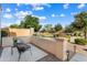 Backyard patio area with comfortable seating and views of the lush green landscape and desert foliage at 16158 W Coronado Rd, Goodyear, AZ 85395