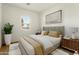 Staged bedroom filled with natural light, a large window, and cozy decor at 16158 W Coronado Rd, Goodyear, AZ 85395