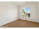 Empty bedroom with neutral carpet and a window offering plenty of natural light at 16158 W Coronado Rd, Goodyear, AZ 85395