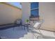 Private courtyard featuring outdoor seating, a patterned rug, and views of the surrounding greenery at 16158 W Coronado Rd, Goodyear, AZ 85395