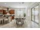 Bright kitchen and dining area with stainless steel appliances, tile flooring, and backyard view at 16158 W Coronado Rd, Goodyear, AZ 85395