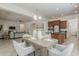 Open concept living space showcases dining table with seating for four, connecting the living room and kitchen at 16158 W Coronado Rd, Goodyear, AZ 85395